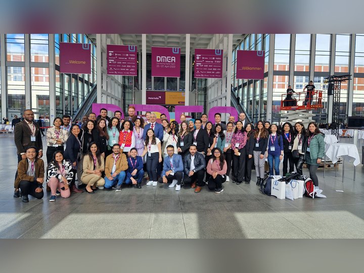 Prof. Georgi Chaltikyan with Master of Digital Health students in front of the DMEA letters at DMEA 2023