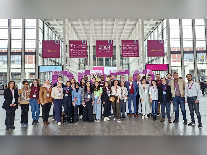 Prof. Georgi Chaltikyan with Master of Digital Health students in front of the DMEA letters at DMEA 2024