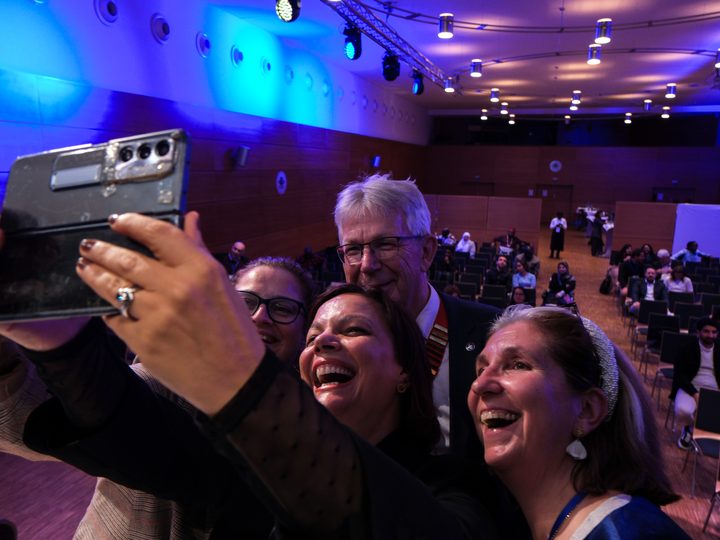 DigiHealthDayS-2025 participants taking a group selfie in the auditorium