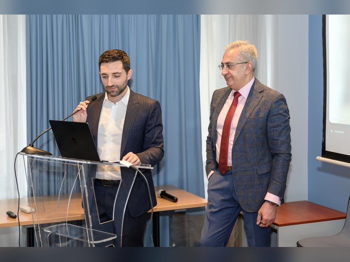 Prof. Georgi Chaltikyan sharing the lectern with a conference colleague